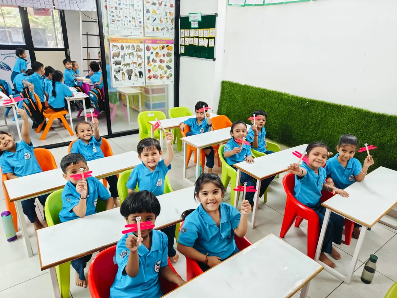 Children displaying their classroom creative activity