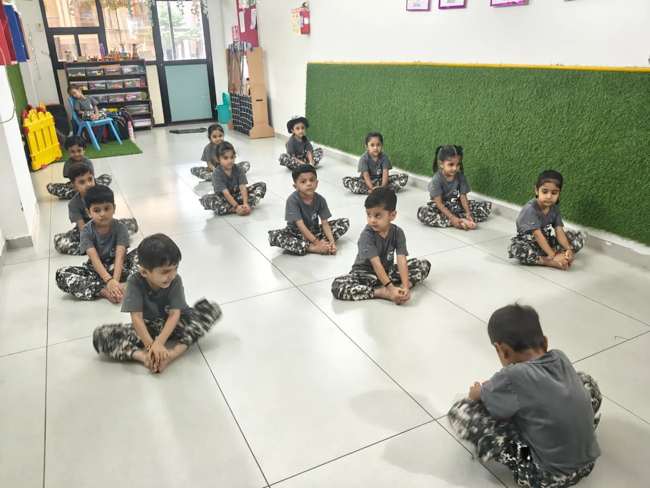 Preschool children taking part in a calm classroom wellbeing activity